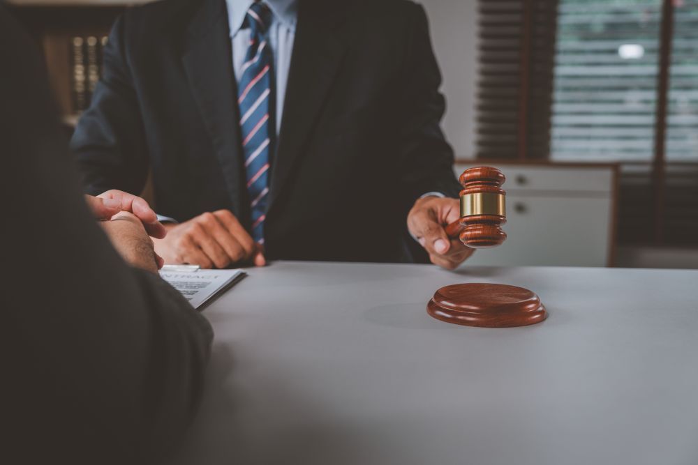 Legal professional with a gavel during a meeting about child neglect law in the UK